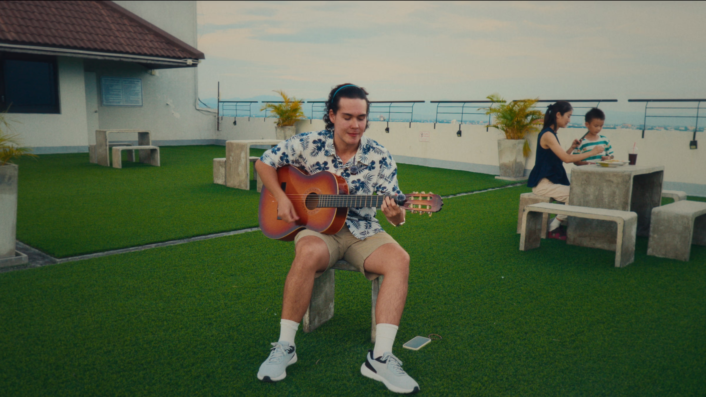 James playing guitar on a rooftop