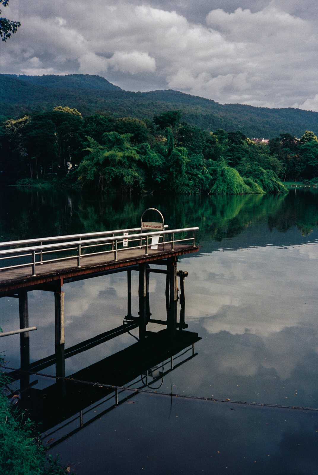 A jetty on a still lake, on film